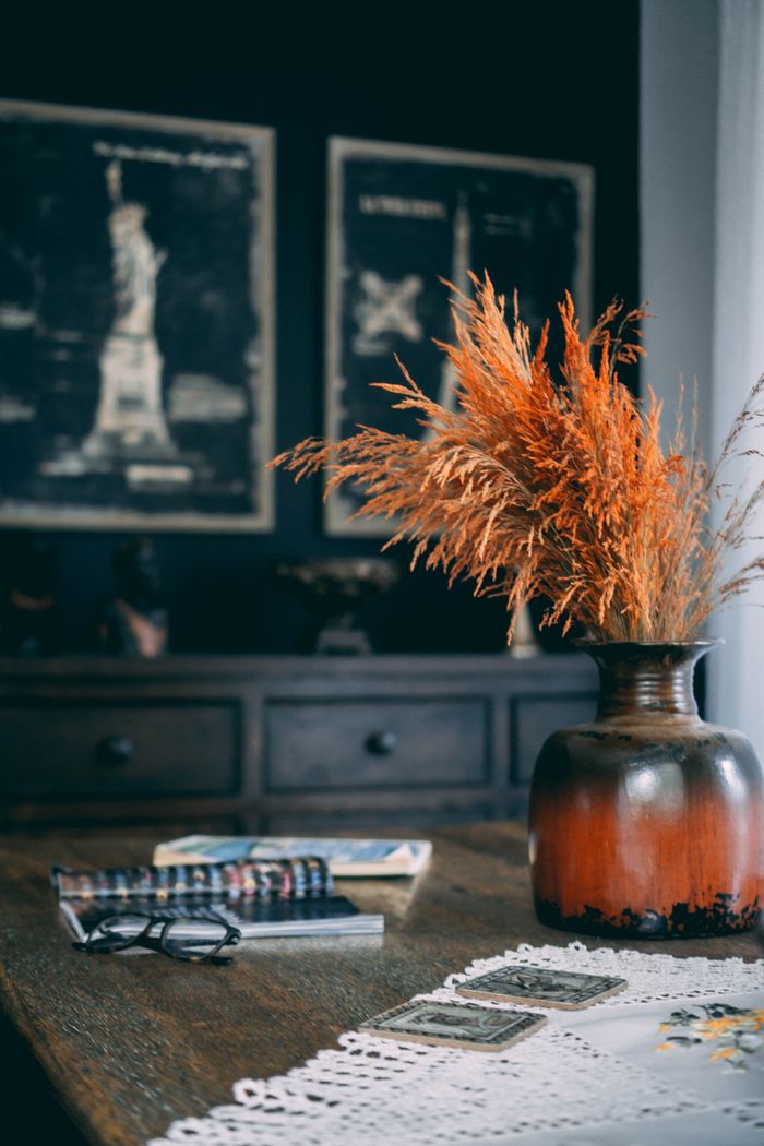 Mastering the First Impression: Your intriguing post title goes here Warm and inviting autumn setting with a rustic vase filled with wheat, cozy decorations, and books.
